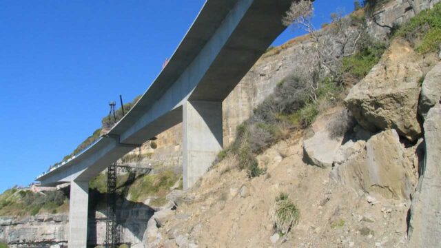Wide shot of a cable-stayed bridge connecting two land areas over calm water