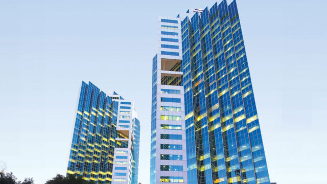 Street view of two modern glass skyscrapers