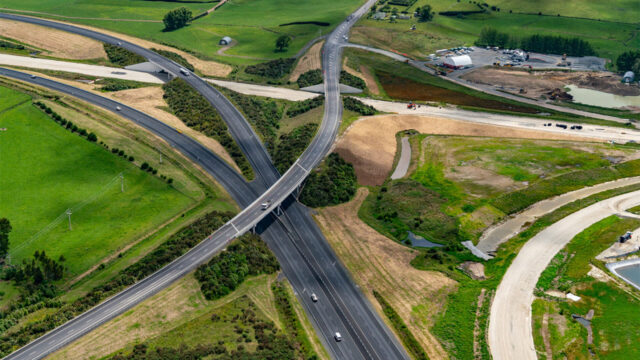 Aerial view of highway interchange with multiple roads and surrounding farmland